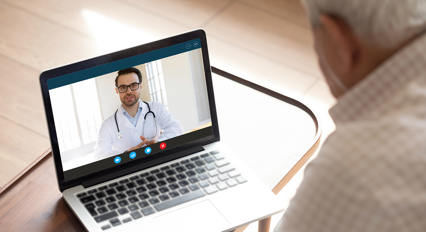 Älterer Patient ist mit seinem Hausarzt in der Videosprechstunde. | © iStock/fizkes